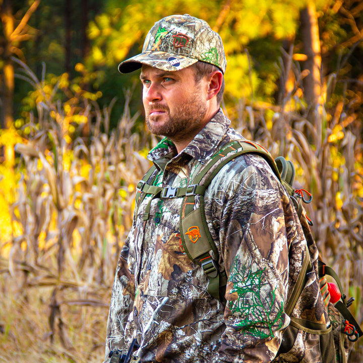 Man in Trek Shirt with a backpack in a forest setting.