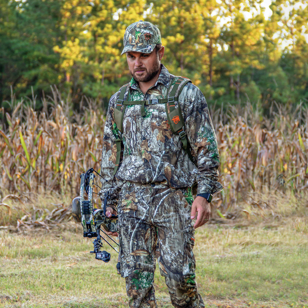 Man in Trek Shirt holding a crossbow in a forest setting.